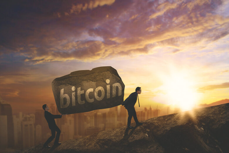 Picture,Of,Two,Businessmen,Carrying,A,Stone,With,Bitcoin,Word